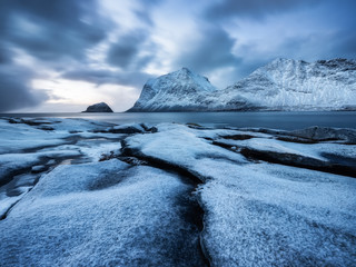 Wall Mural - Haukland beach, Lofoten islands, Norway. Landscape with long exposure shot. Mountains, beach and clouds. Winter landscape near the ocean. Norway - travel