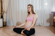 © Andrii - A pregnant girl does yoga at home. Health