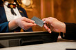 © Svitlana - Share a grand experience. Close up of male and female hands. Man is giving privileged personal card to female receptionist for paying