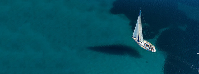 Wall Mural - Aerial drone ultra wide photo of beautiful sail boat sailing in tropical exotic bay with emerald clear sea