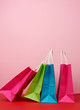 © nndanko - Four empty multicolored paper bags for shopping and gifts with white handles