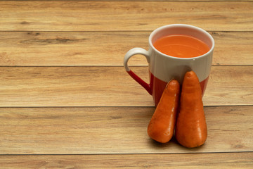 Glasses of carrot juice with vegetables on table close up