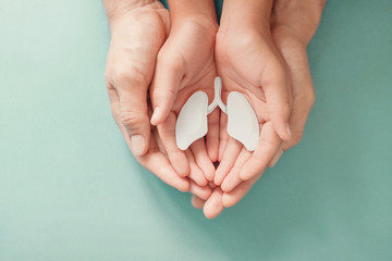 Adult and child hands holding lung, world tuberculosis TB day, lung cancer, copd, respiratory diseases concept