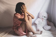 © AungMyo - Sad young girl sitting in room. human trafficking concept.