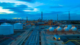 Fototapeta Psy - Oil refinery plant from industry zone, Aerial view oil and gas petrochemical industrial, Refinery factory oil storage tank and pipeline steel at night, Ecosystem and healthy environment concepts.