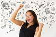 © Mangostar - Hand drawn education pictures with excited woman raising fists. Cheerful young Asian woman triumphing and celebrating success isolated on white background. Winner concept
