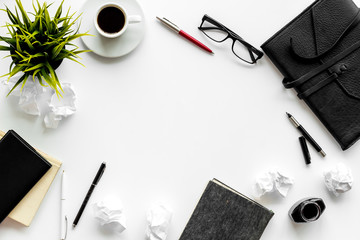 Journalist's desk. Notebook, pen, crumpled paper on white background top-down frame copy space