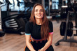 © fotofabrika - Woman fitness trainer portrait on a gym background