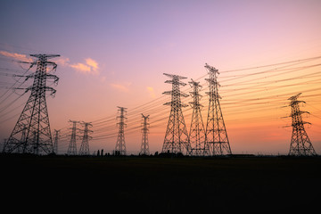 Canvas Print - High voltage power tower and beautiful nature landscape at sunset