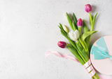 Fototapeta Tulipany - Tulips easter flat lay with pink and white flowers and eggs on white background