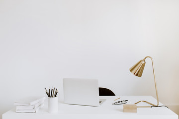 Wall Mural - Office with laptop, lamp, notebooks. White working study cabinet. Outsourcing freelancer, blogger, boss workspace.