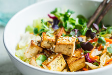 Fried Tofu Salad With Sprouts And Sesame Seeds In White Bowl. Vegan Food, Asian Food Concept.