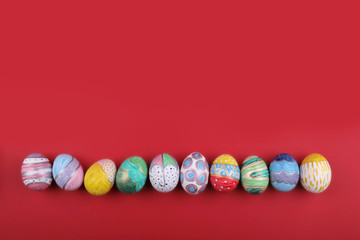 Wall Mural - painted handmade easter eggs on a red background