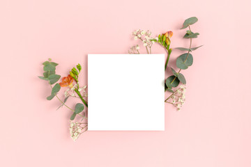 Wall Mural - blank paper card mockup with frame made of flowers and eucalyptus. floral composition with copy spac