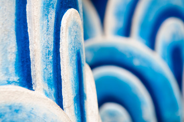 Selective focus view of colorful blue abstract wave motif in three dimensional arches at a Buddhist temple in Bangkok, Thailand