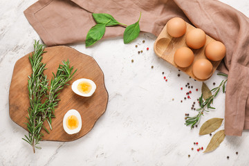 Boiled eggs with spices and herbs on white background