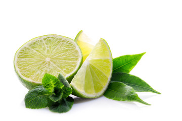 Wall Mural - Slices of ripe and juicy lime with green mint leaves close-up