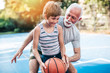 © hedgehog94 - Grandfather and his grandson playing basketball.