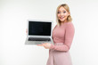 © Ivan Traimak - short-haired girl with white hair shows a laptop screen with an empty blank on a white studio background