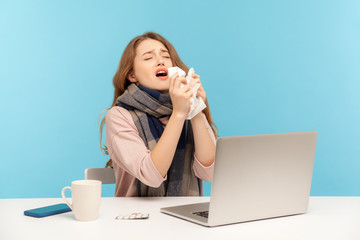 Flu-sick girl sneezing in tissue, ill freelance woman coughing suffering fever, seasonal influenza symptoms while working on laptop at home office, syndrome allergy. indoor studio shot blue background