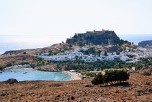 Lindos, Rhodes, Greece. Overview Of Lindos. Spectacular View To The Beach, Lindos Village And The Acropolis Of Lindos With Temple Of Athena Lindia