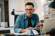 © JustLife - Designer in office. Businessman working on new architect project.