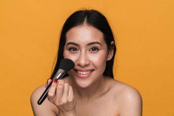 Poster - Beauty portrait of young half-naked woman applying cosmetics with brush