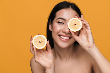 Sticker - Beauty portrait of young half-naked woman smiling and holding lemon parts