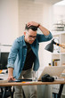 © JustLife - Tired businessman in office. Young architect overworked.
