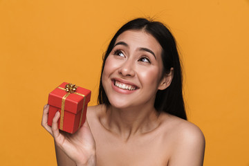 Poster - Beauty portrait of half-naked woman smiling while holding present box