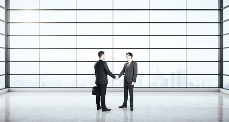 Sticker - Businessmen shaking hands in modern interior