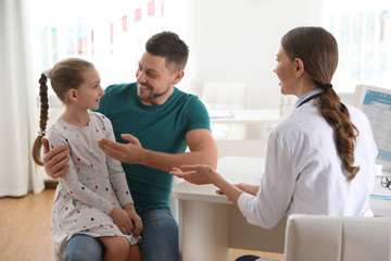 Sticker - Father and daughter visiting pediatrician. Doctor working with little patient in hospital