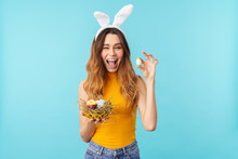 Portrait Of Young Woman Holding Basket With Painted Easter Eggs