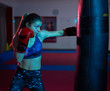 © Xalanx - Boxer girl hitting the heavy bag