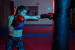 © Xalanx - Boxer girl hitting the heavy bag