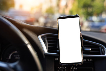 Modern smartphone device gadget mounted on phone holder at car dashboard. Mock-up white screen isolated template. Copyspace for text . Vehicle interior cockpit view. Traffi jam info app
