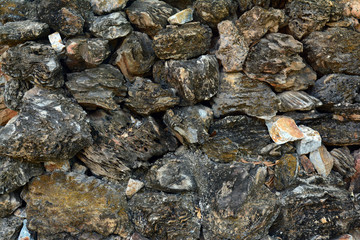 Wall Mural - the wall of black mountain stones in garden resort