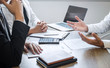 © Ngampol - Employer or recruiter holding reading a resume with talking during about his profile of candidate, employer in suit is conducting a job interview, manager resource employment and recruitment concept