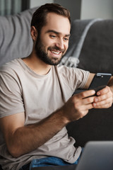 Canvas Print - Happy young man chatting by mobile phone.