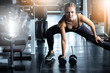 © Yingyaipumi - Young girl playing dumbbell to exercise in fitness.Cinematic tone of Slim girl lifts heavy dumbbell while training in the gym.Concept of individual sport to fit muscles of body for healthy life.