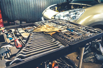 Fixing tools in open box at car repair shop