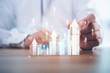 © Looker_Studio - Business development to success and growing growth concept.businessman try to arrange wooden blocks into growing graphs.