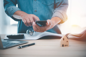 Leinwandbilder - Hand man using smart phone for Searching Browsing Internet Data Information Networking Concept.Find information about building a house.