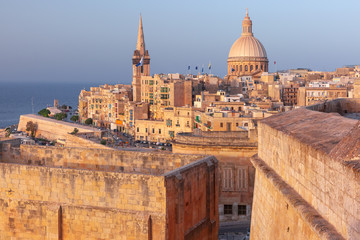 Fototapete - View of Old town roofs, fortress, Our Lady of Mount Carmel church and St. Paul's Anglican Pro-Cathedral at sunset , Valletta, Capital city of Malta
