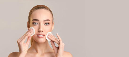 Wall Mural - Girl Using Cotton Pads Doing Skincare Routine, Beige Background, Panorama