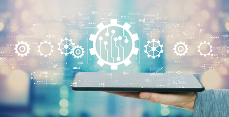 Automation concept with man holding a tablet computer