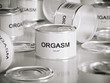 several white tin cans with orgasm title
