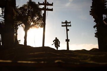 War Concept. Military silhouettes fighting scene on war fog sky background, World War Soldiers Silhouette Below Cloudy Skyline At sunset.