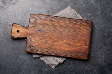 Cutting board over towel on stone kitchen table