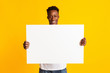 © Prostock-studio - Excited african american man holding blank poster